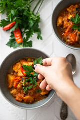 Ratatouille in a bowl with fresh chilli pepper, top view 