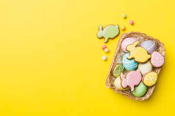 Multi colors Easter eggs in the woven basket on colored background . Pastel color Easter eggs. holiday concept with copy space