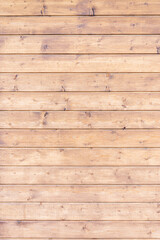 Obraz premium The polished wooden boards are fitted together. A table or fence, a wooden wall made of planks.