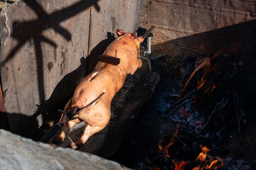 Rotisserie or spit-roasting pig, pork roasted on spit.