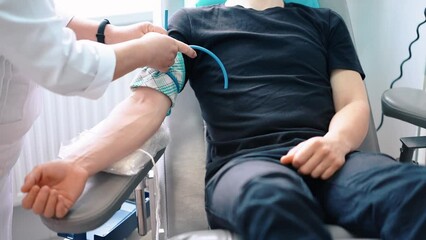 world blood donor day, blood sampling from a man, close-up, nurse and patient