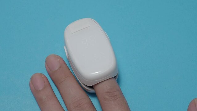 Oximeter usage. Finger pulse oximeter used to measure pulse rate and oxygen levels. Home self care during Covid 19 pandemic. healthcare monitoring concept. using portable fingertip pulse oximeter. 4k
