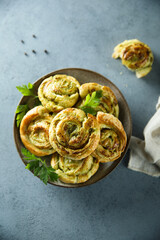 Homemade puff pastry swirls with pesto sauce