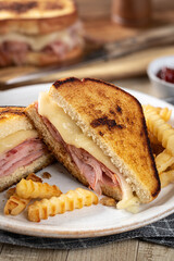 Grilled ham and cheese sandwich with french fries