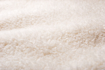 Light natural sheep wool close up. Texture of fluffy fur for designers.