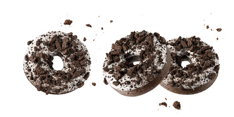 White chocolate glazed donut with dark cookies crumbs and creme filled closeup flying.
