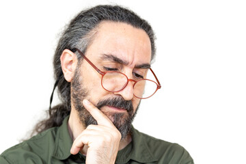Middle aged bearded man with glasses in selective focus thinking with hand on chin, index finger on cheek. Thinking middle aged man on isolated white background. - obrazy, fototapety, plakaty