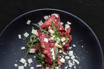 Marbled beef carpaccio with arugula and parmesan cheese