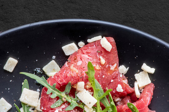Marbled beef carpaccio with arugula and parmesan cheese