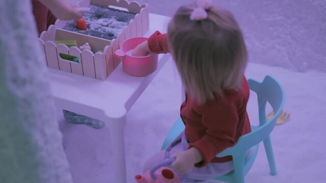 Infant girl playing in salt room 