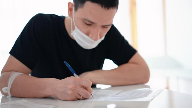 a man fills out paperwork, world donor day, polyclinic