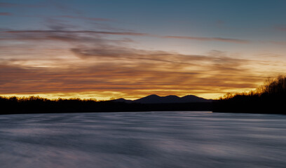 Mountain Motajica and Sava river at twilight with colorful clouds