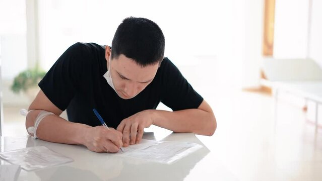 a man fills out paperwork, world donor day, polyclinic
