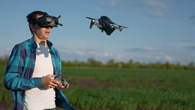 agriculture. man farmer a aerial pilot drone survey explorers green wheat crops in the field. agriculture modern business concept. man farmer works in field. agritech drone technology in agriculture