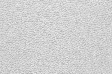 Close-up of a white leather and textured background.