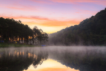 Fototapeta na wymiar Morning in pang oung with the light and reflection steam over the lake with pine tree forest nature background, Mae Hong Son, Thailand
