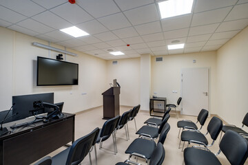  rows of seats in interior of modern empty conference hall for business meetings