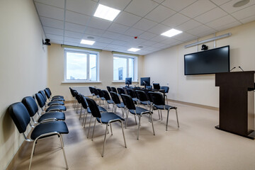  rows of seats in interior of modern empty conference hall for business meetings
