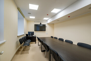  rows of seats in interior of modern empty conference hall for business meetings