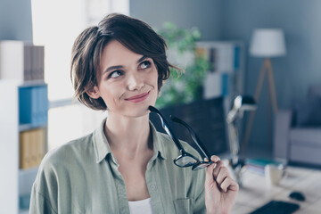 Photo of minded charming lady hold eyeglasses creative decision contemplate office room workstation