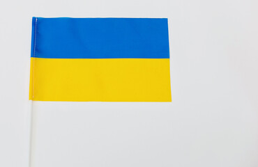 The national flag of Ukraine on a white background fabric. Place for the inscription.
