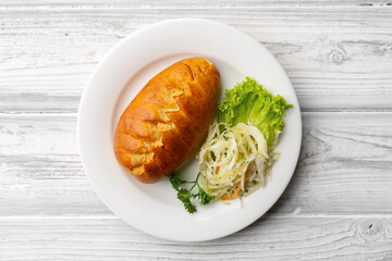 Traditional Russian pie or patty on white plate