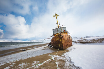 Ship washed ashore near Teriberka. Winter landscape. Russia