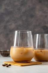 Irish cream liqueur in glasses with ice cubes and coffee beans