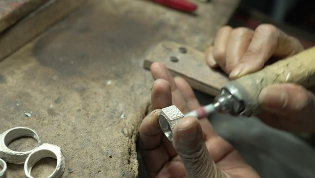 Jeweler at work in jewelry. Desktop for craft jewelry making with professional tools. Close up view of tools. Thailand.	