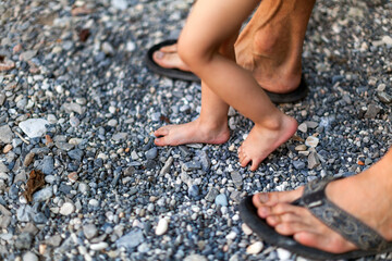 The first steps of the baby with the help of father