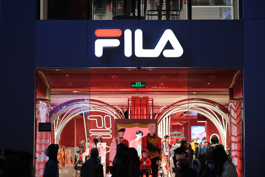 Shanghai,China-Jan.1st 2022: facade of Fila store exterior and brand logo at night. sportswear company 