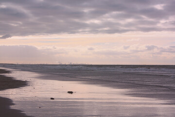 Fototapeta na wymiar Marine scenery including a city silhouette on the horizone