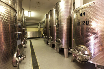 Stainless steel reservoirs for wine at modern winery, Italy