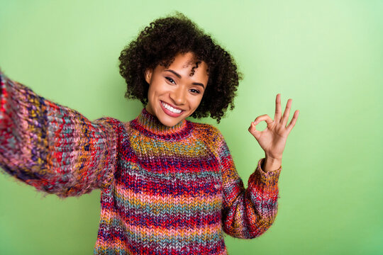 Photo of hooray young valume hairdo lady do selfie show okey wear colorful turtleneck isolated on green color background