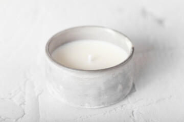 Obraz na płótnie Canvas Candle with natural soy wax. A candle in a plaster mold. Interior candle. Creating comfort.