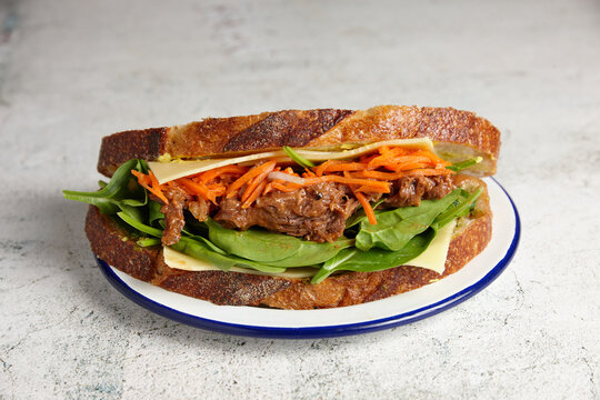 Pulled beef, cheese and salad sandwich on sourdough bread