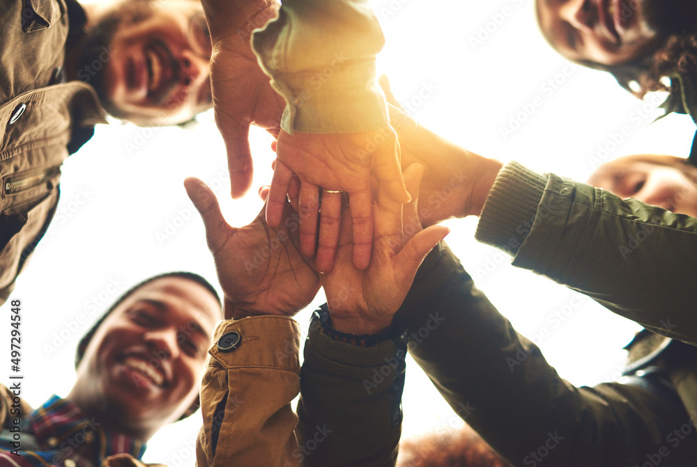 Aufkleber Making a pact to stay friends forever. Low angle shot of a group of friends piling their hands while standing outside.