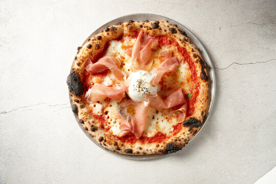 Gourmet wood fired ham pizza on table