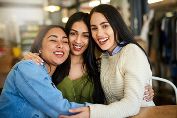 Its our favourite cafe to catch up. Portrait of a group of young friends hanging out in a cafe.