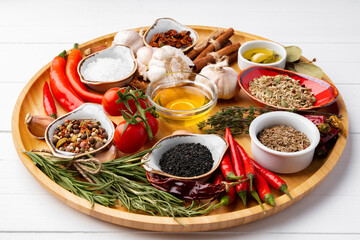 Oil, herbs and spices on wooden background