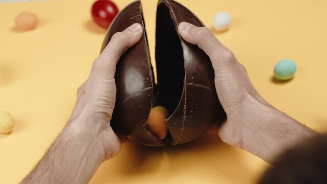 Opening chocolate easter egg with surprise