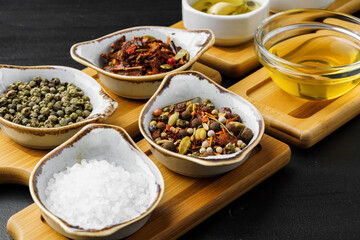 Oil, herbs and spices on wooden background
