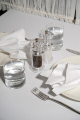 Table setting with plate, knife, fork and napkin