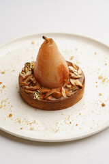 Tart cake with baked pear and almond