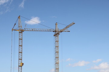 Construction of new residential high-rise buildings. Against the background of a yellow sunset sky.