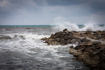 Ocean waves against a rocky coast on a stormy day.