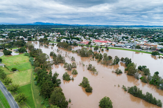 Flooding river with floodwaters reaching up the levee bank