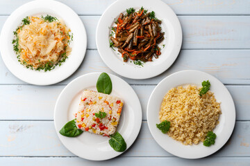Variety of garnishes like cooked rice, bulgur, stewed cabbage and green beans