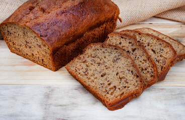 freshly baked rustic style banana bread loaf on country style table