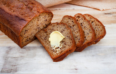 freshly baked rustic style banana bread loaf on country style table